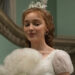 Phoebe Dynevor as Daphne Bridgerton holding a fan up. .