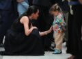 Meghan Markle meets a young child during a visit to the Royal Children's Hospital Melbourne.
