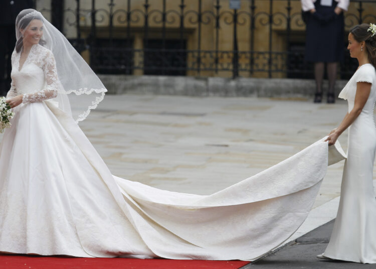 Kate Middleton, left, and accompanied by maid of honour Pippa Middleton as they arrive at Westminster Abbey at the Royal Wedding in London Friday, April 29, 2011.