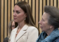 The Princess of Wales and the Princess Royal listen to a midwife