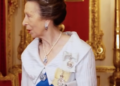 Princess Anne wears a white dress with a large collar effect and an aquamarine and diamond tiara