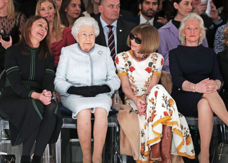 Queen Elizabeth II sits with Anna Wintour (third right) and Caroline Rush, chief executive of the British Fashion Council (BFC) (left) and royal dressmaker Angela Kelly (second right) during a 2018 London Fashion Week show