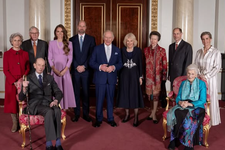 The Royal Family stand in a room n Buckingham Palace for an official portrait