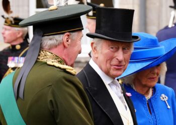 King Charles III smiles during a garden party at the Palace of Holyroodhouse in Edinburgh, Scotland, on July 1, 2025, on the first day of the king and queen's visit to Scotland.
