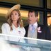 Harriet Sperling and Peter Phillips during day one of Royal Ascot at Ascot Racecourse, Berkshire. She is wearing a white jacket with puffed sleeves and a straw hat which sits at an angle on her long, blonde hair. He is wearing a dark-coloured jacket, a light grey waistcoat, a pink shirt with a white collar and a light blue tie.