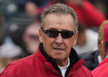 Los Angeles Angels owner Arte Moreno standing on the field at Tempe Diablo Stadium