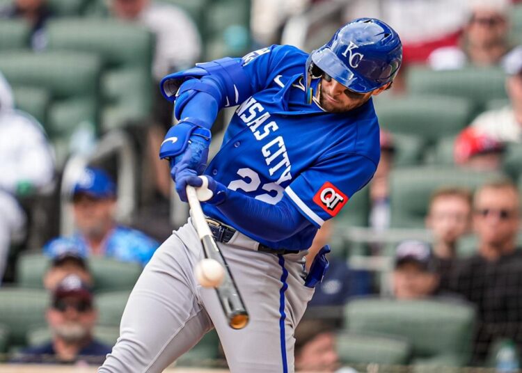 Kansas City Royals catcher Carter Jensen (22) swings at a pitch.