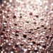 An extreme close-up of shimmering, glittering sequins in dramatic, high-contrast studio lighting, conceptually representing the glamour and pressures of Hollywood celebrity culture.