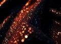 An extreme close-up photograph of a shimmering, high-contrast fabric texture like sequins or velvet, capturing the luxurious and vibrant atmosphere of a film set through abstract, high-fashion imagery.