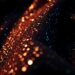 An extreme close-up photograph of a shimmering, high-contrast fabric texture like sequins or velvet, capturing the luxurious and vibrant atmosphere of a film set through abstract, high-fashion imagery.