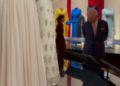 King Charles looks at clothes belonging to Queen ELizazbeth II