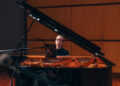 Woman plays piano.
