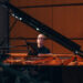 Woman plays piano.