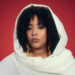 A headshot of Sulaf wearing a traditional white outfit.