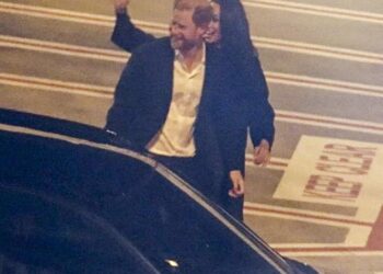 Meghan Markle waves and Prince Harry smiles as they land in Sydney