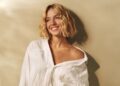 The Euphoria actress poses in a loose-fitting white shirt and a pair of denim shorts