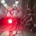 An abstract close-up photograph of shattered glass reflecting a faint red light, conveying a sense of disruption and exposure surrounding the political elite.