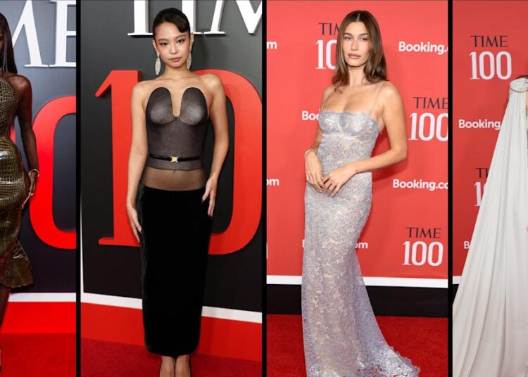 Group of four women in fashionable attire at an event.