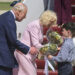 King Charles III and Queen Camilla receive posies from the children of British military families based in the United States, at Joint Base Andrews, Md., Monday, April 27, 2026. They are in the U.S. for a four-day state visit aimed at celebrating the United States' 250th anniversary, including a White House state dinner and a speech to Congress.