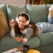 WOMAN LISTENING TO MUSIC ON COUCH