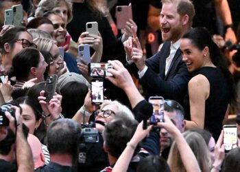 Prince Harry, Duke of Sussex, and his wife Meghan, Duchess of Sussex, meet people at the Royal Children's Hospital in Melbourne on April 14