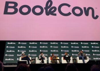 Panel discussion at BookCon featuring multiple speakers.