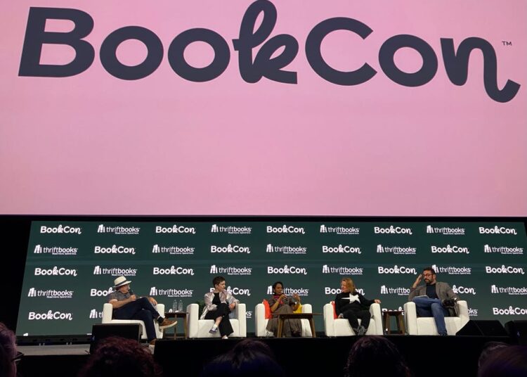 Panel discussion at BookCon featuring multiple speakers.