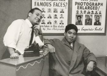 Dave Sharkey with a customer in 1962. The small shop featured its celebrity customers framed on the wall. - Courtesy Philip Sharkey