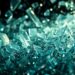 An abstract close-up image featuring shattered glass and glittering sequins, captured in dramatic high-contrast studio lighting to evoke the glamour and mystery of the entertainment industry.