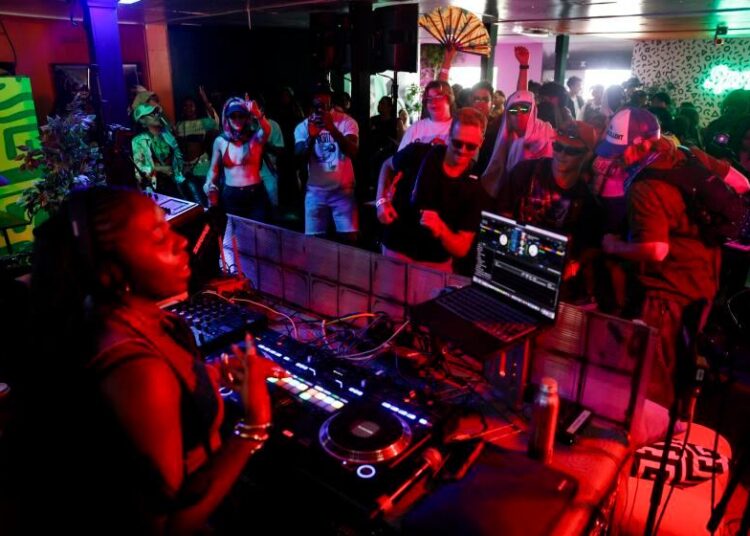 INDIO, CA - APRIL 12, 2026: Festival goers dance while Kailyn Brown performs during her dj set at the Party