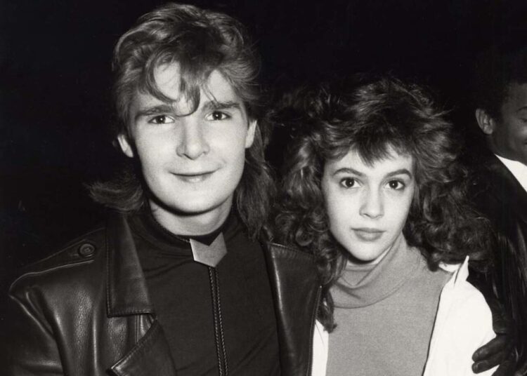 Actors Corey Feldman and Alyssa Milano during the 1987 American Music Awards in Los Angeles. -