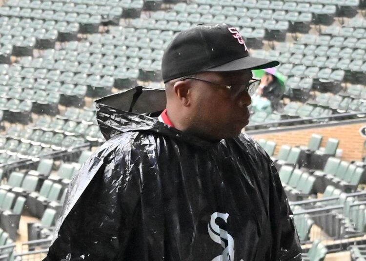Jul 30, 2025; Chicago, Illinois, USA; Chicago White Sox fans walk upstairs in rain ponchos before a rain delay is announced prior to a game against the Philadelphia Phillies at Rate Field. Mandatory Credit: Patrick Gorski-Imagn Images