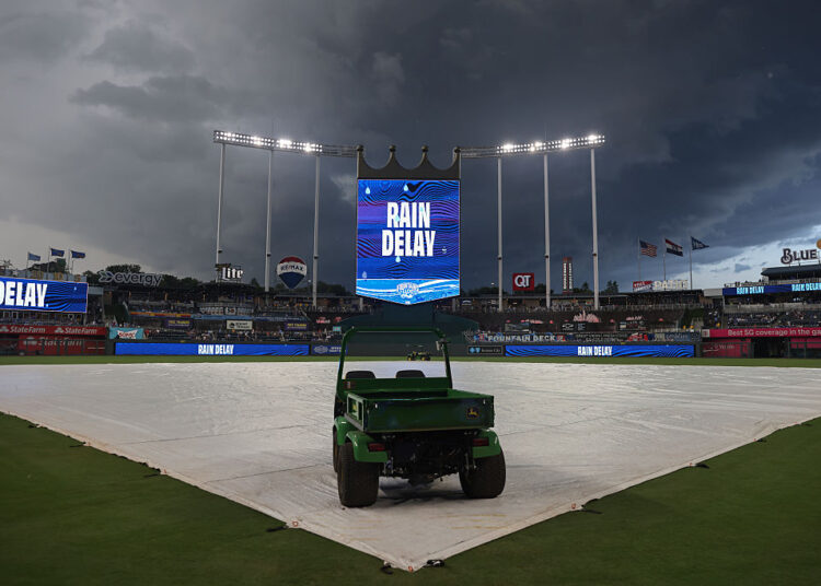 KANSAS CITY, MO - JULY 11: Dark clouds fill the skies as the scoreboard shows a rain delay before an MLB game between the New York Mets and Kansas City Royals on July 11, 2025 at Kauffman Stadium in Kansas City, MO. (Photo by Scott Winters/Icon Sportswire via Getty Images)
