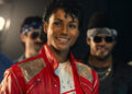 Jaafar Jackson as Michael Jackson smiling in his red jacket in the Michael biopic