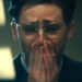 Timothee Chalamet crying with his hands on his mouth as Marty Mouser at the end of Marty Supreme .