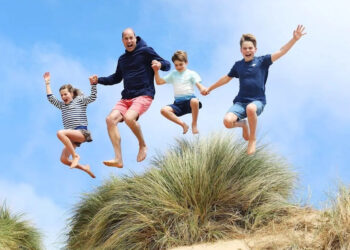 Prince William jumping with George, Charlotte and Louis on Norfolk beach