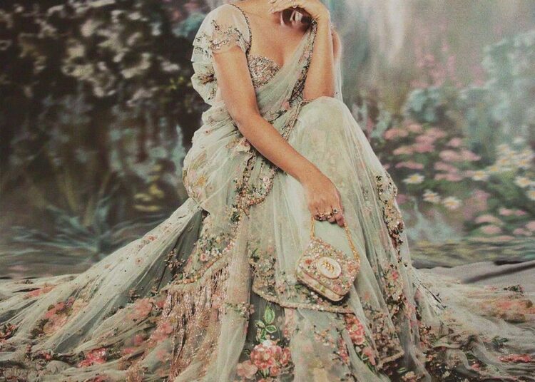 Alia Bhatt: At the Met Gala 2024, Alia Bhatt set the internet abuzz in a custom mint-green sari by Sabyasachi, complete with a dramatic 23-foot train. The ensemble featured intricate floral embroidery crafted with silk floss, glass beads, and semi-precious stones. She styled her hair in a loose updo, adorned with strands of gemstones that echoed the sari’s detailing, and finished the look with statement tourmaline-and-diamond earrings and stacked cocktail rings from Sabyasachi Accessories. (Image: Instagram)