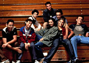 Group of young adults casually seated on bleachers, each displaying a distinct relaxed fashion style