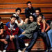 Group of young adults casually seated on bleachers, each displaying a distinct relaxed fashion style