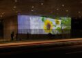 A video projection of flowers on a concrete wall.