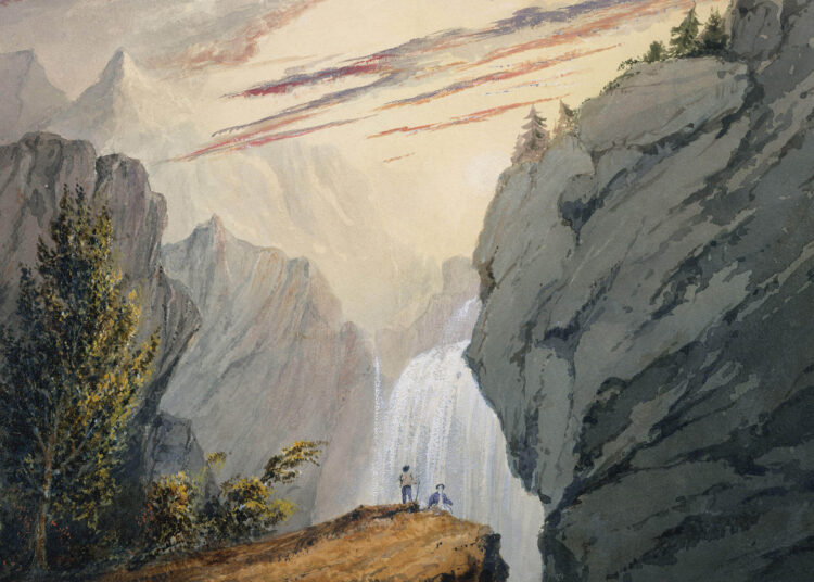 Two small people in front of a waterfall