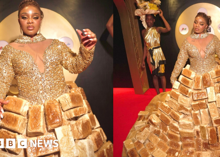 Reality TV star Queen Mercy Atang  is seen with her dress made from loaves of bread
