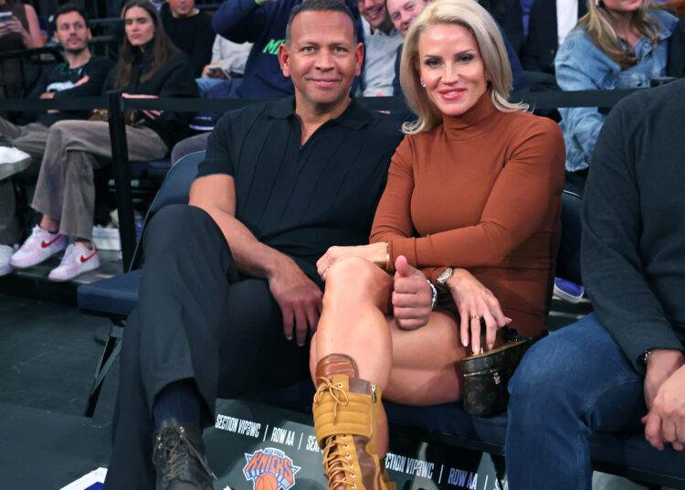 Alex Rodriguez and Jaclyn Cordeiro sitting courtside at a basketball game.