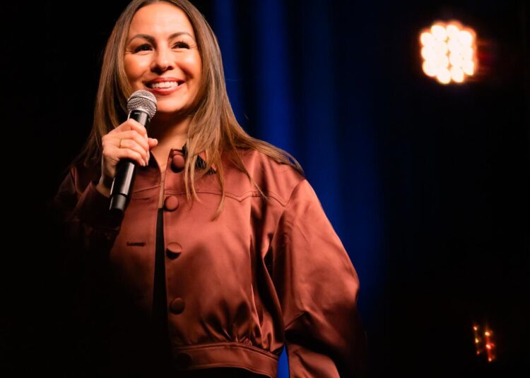 Woman on stage with a microphone