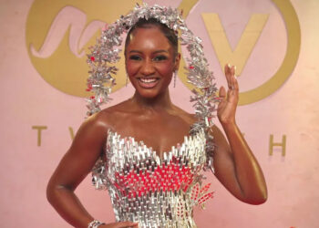 Actor and event host Simi Drey is draped in starlight, in a dress entirely made from glass designed by Ovems