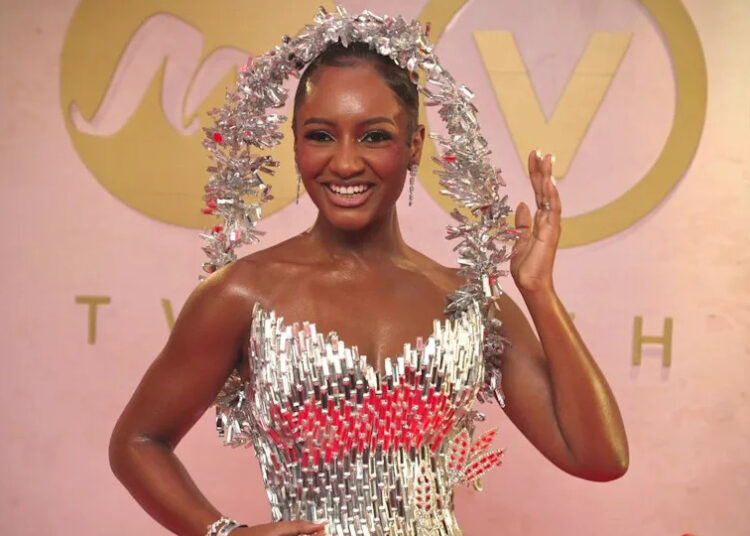 Actor and event host Simi Drey is draped in starlight, in a dress entirely made from glass designed by Ovems