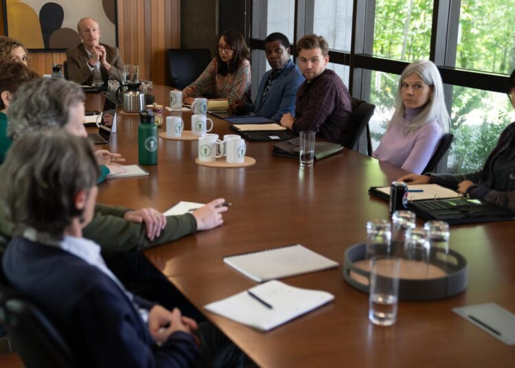 A group of college professors around a conference table