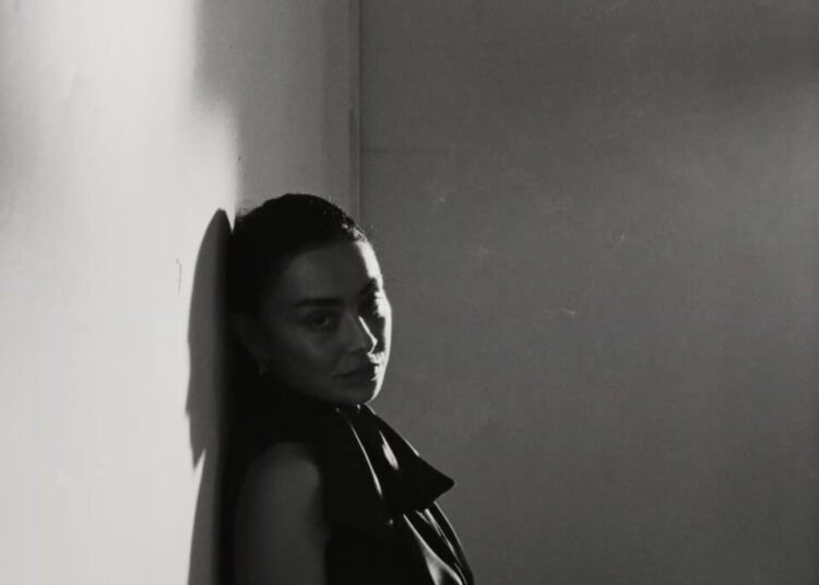 Charli XCX standing in the Rock Music video.