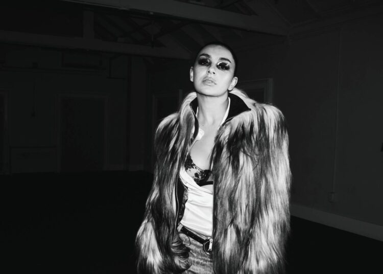 Charli XCX walks Paris runway "straight to hell" on gritty new single 'SS26'