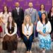 Group of award recipients wearing medals pose for a photo in front of a University of Scranton backdrop.